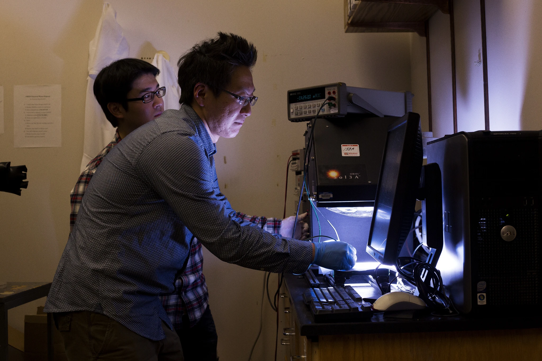 A member of the research team tests the conductivity of a colored solar cell (Photo: Joseph Xu, Michigan Engineering Communications & Marketing)
