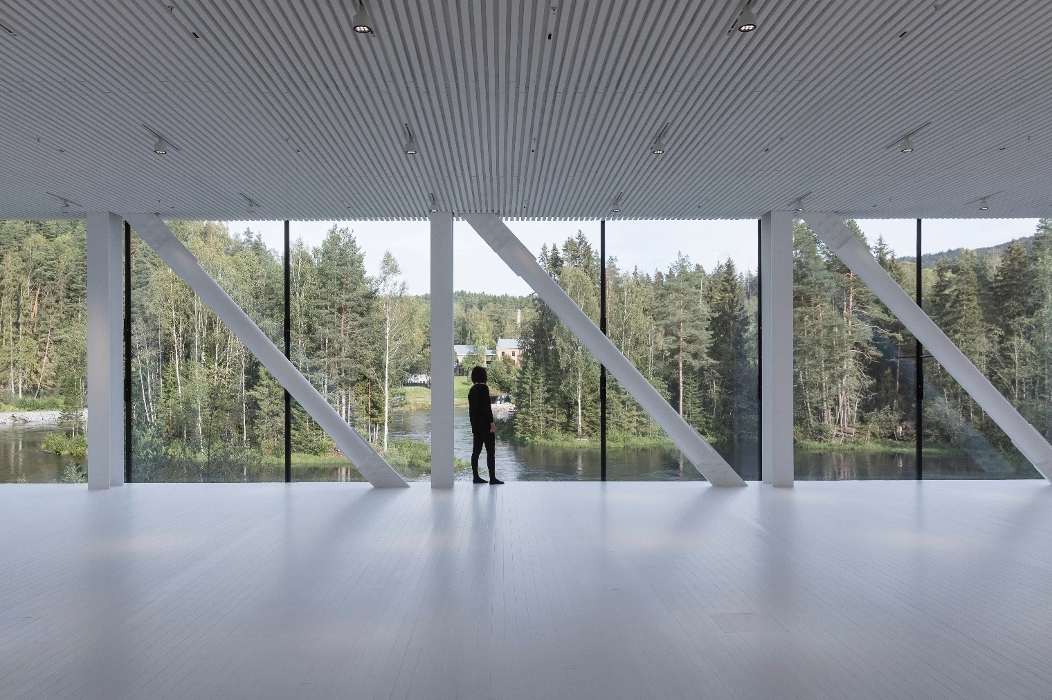 The Twist features a full-height glass wall that tapers upwards to form a thin skylight, and offers panoramic views of a nearby pulp mill