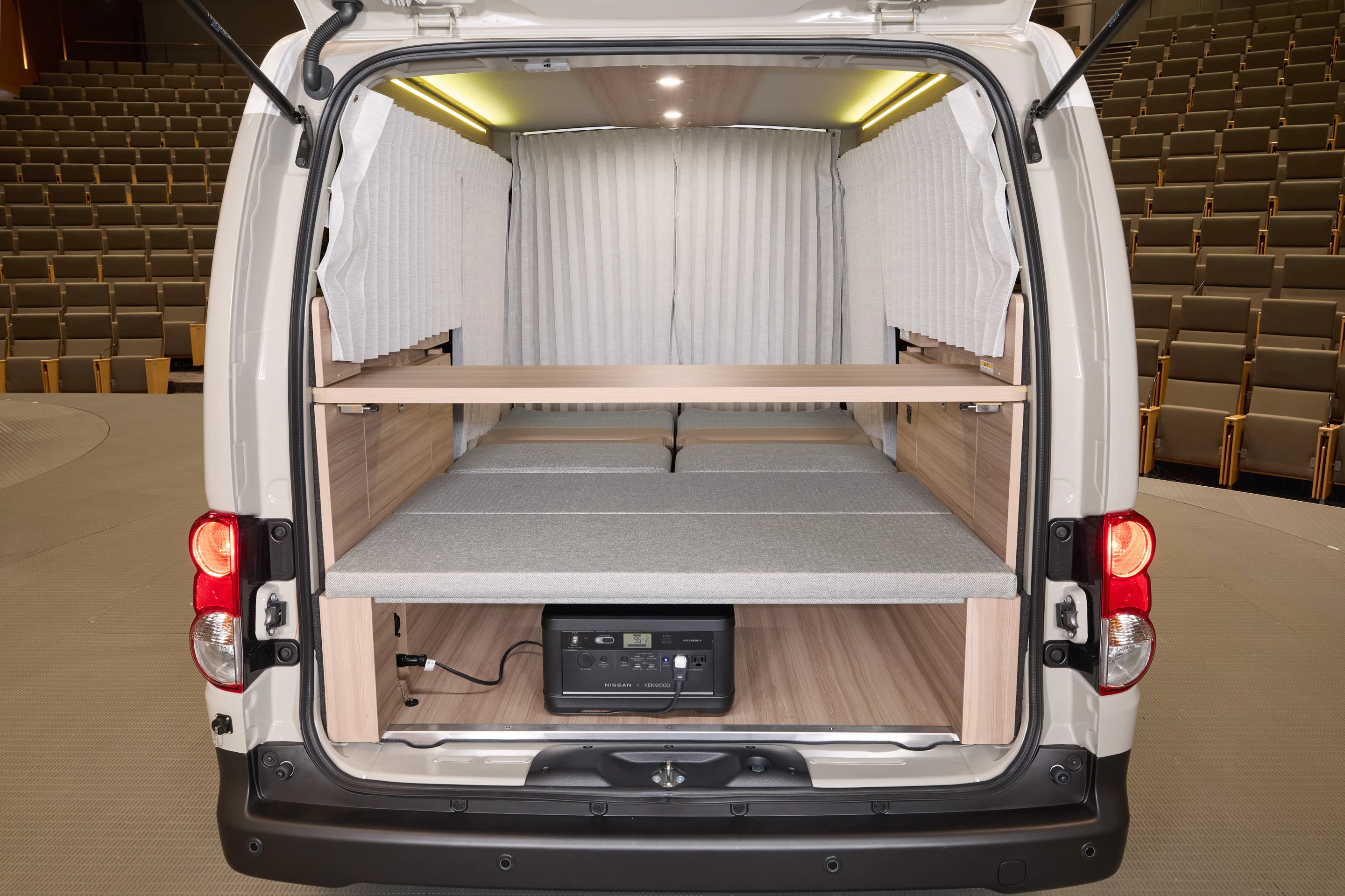 Sleeper configuration with available curtains, optional power station and table set up for a possible breakfast in bed