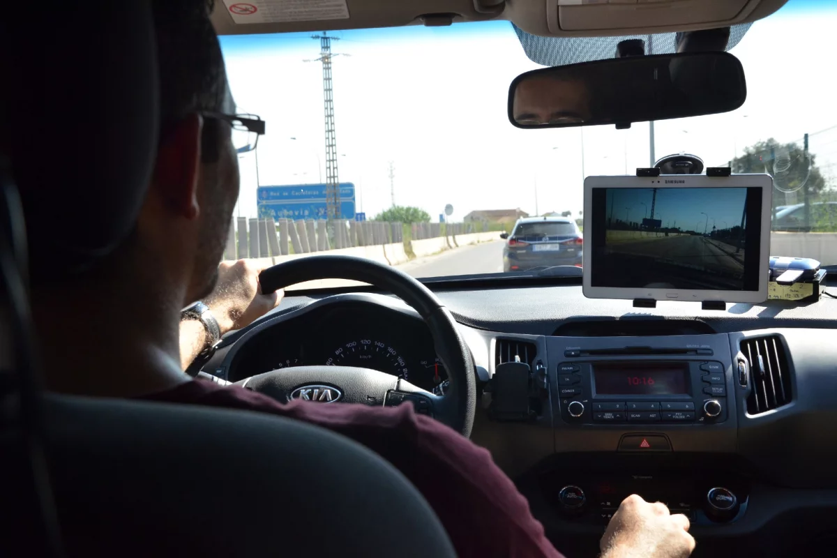 A driver checks the road ahead of the car he's following, using EYES tech
