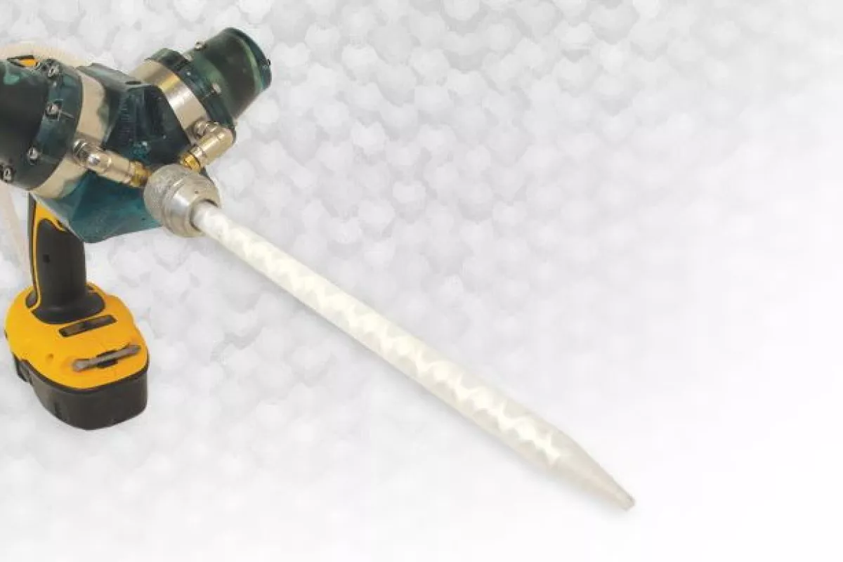 The Dra-gun is a drill-powered device for mixing and applying two-part liquids such as resin