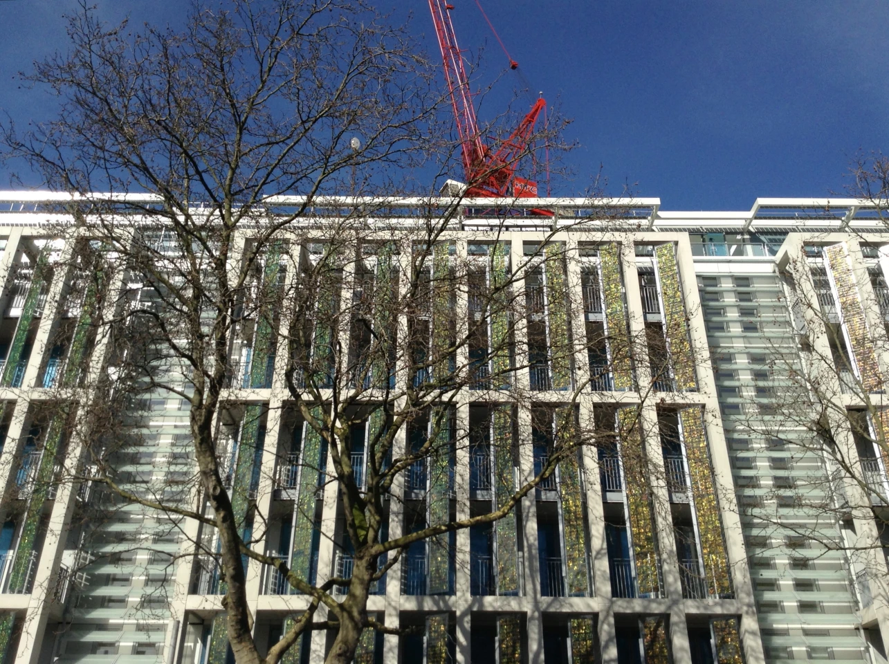 Kingsgate House under construction in Chelsea, London with gold solar shutters at the windows (Photo: Horden Cherry Lee Architects)