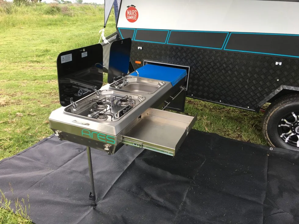 The slide-out kitchen offers outdoor cooking