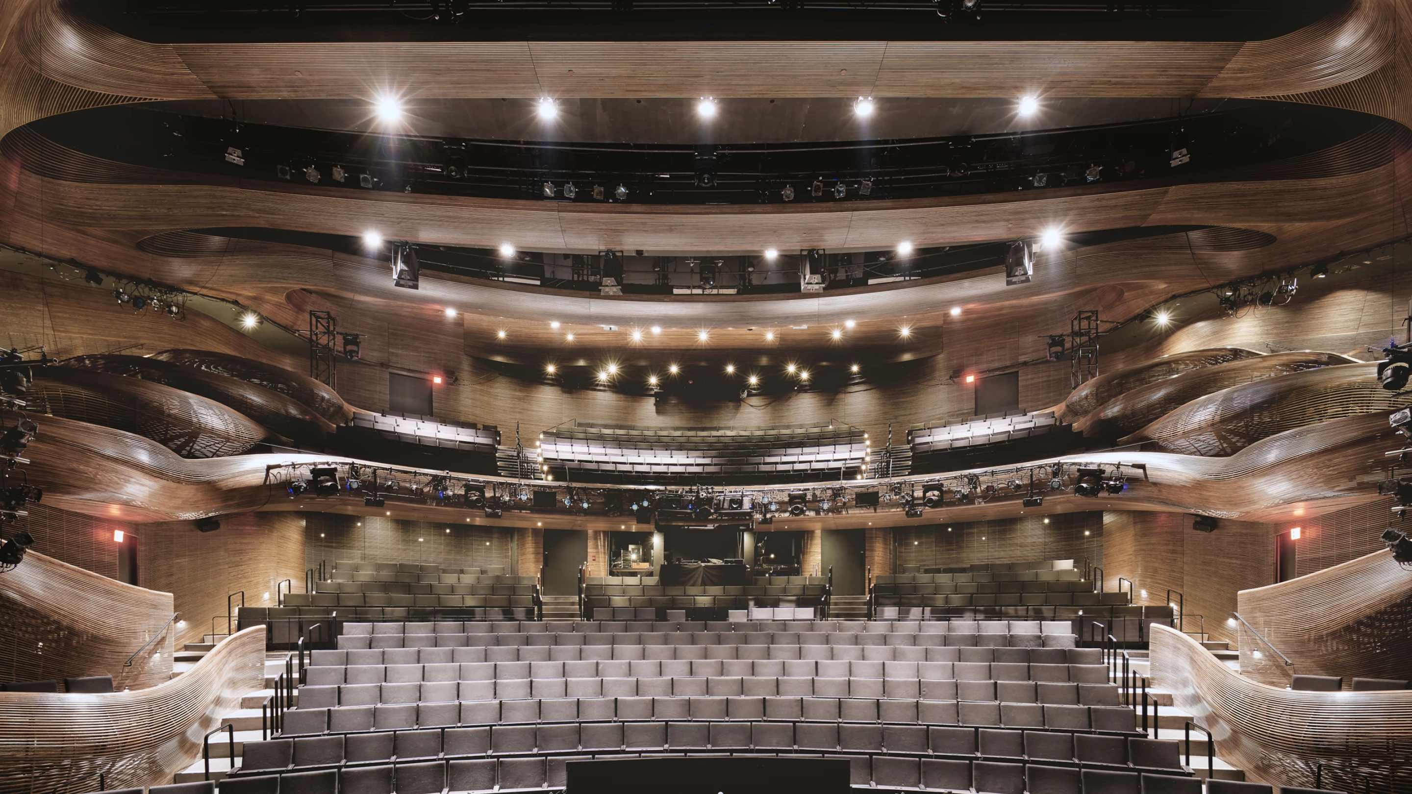 Coca-Cola Stage at the Alliance Theatre is defined by beautiful steam-bent wooden railings and balconies. The project is one of this year's winners of the AIA 2021 Interior Architecture Awards
