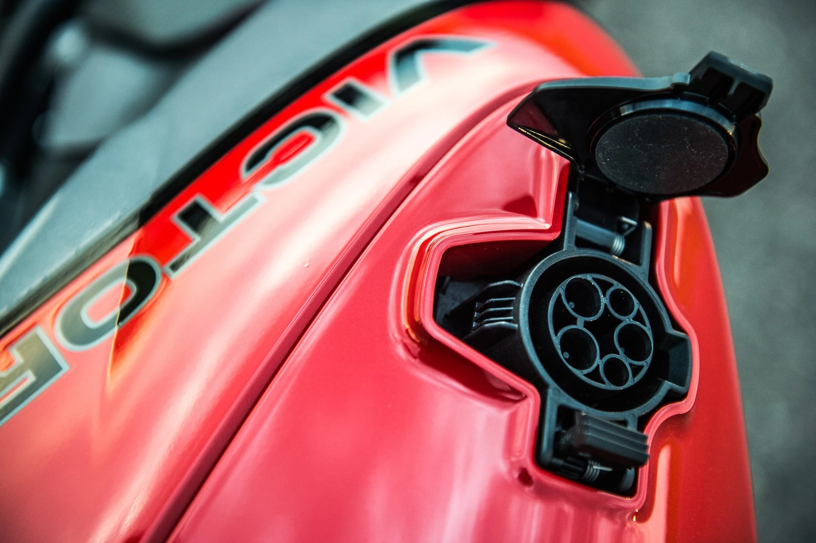 The bike has a built-in battery charger accessible through a SAE J1772 plug