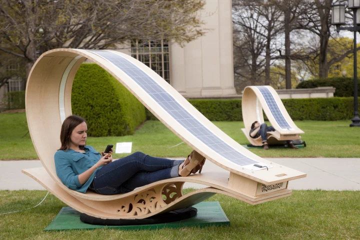 Developed for MIT's Festival of Art Science Technology, the SOFT Rockers use enhanced fabrication techniques to curve flat wooden panels, and have solar panels installed to charge the gadgets of those who relax within (All images courtesy of Phil Seaton)