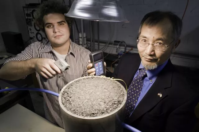 University of Rhode Island graduate student Andrew Correia (left) and Prof. K. Wayne Lee, measuring the solar energy generated by a patch of asphalt