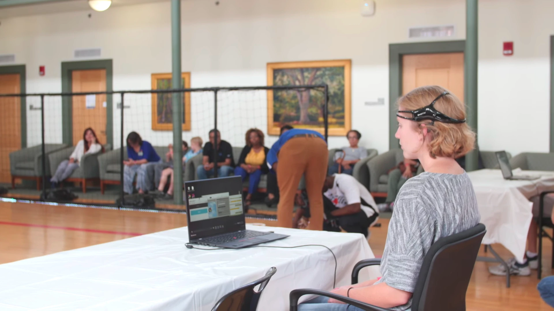 Competitors don brain-computer interfaces and focus in on an object floating on the computer screen in front of them