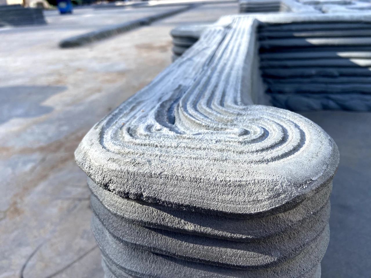 The 3D printer used in the construction of the home extrudes a cement mixture out of a nozzle in layers, building up the basic structure