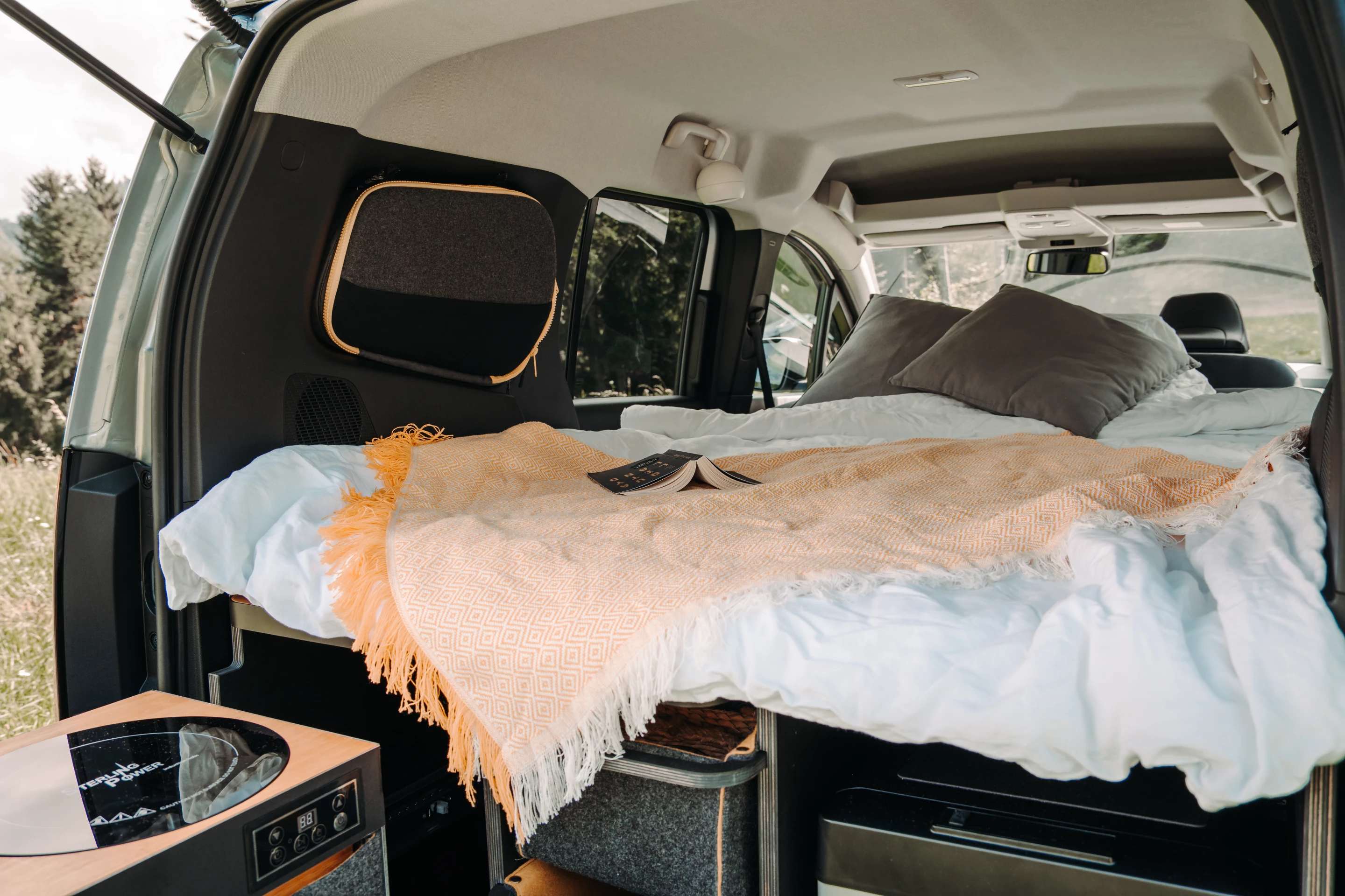 The Habiton 2 sleeps two atop its lower convertible bed and includes a window shade that doubles as a carry bag