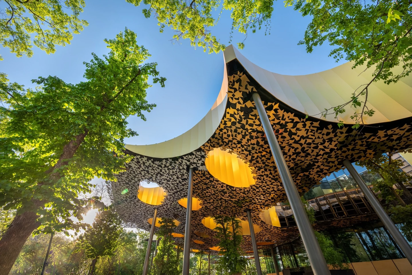 House of Music, Hungary was designed by Sou Fujimoto & Liget Budapest Project. The museum is dedicated to music and features a perforated roof and an overall design that helps it blend in with the surrounding forest. The project won the Architectural Design of the Year prize in the 2022 Architecture MasterPrize