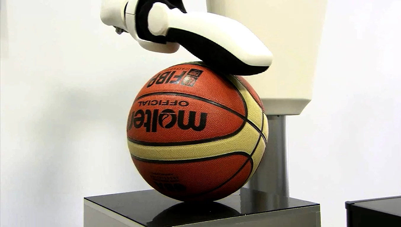 A rigid robot arm would push this ball right off the table, but Toyota's arm simply comes to rest