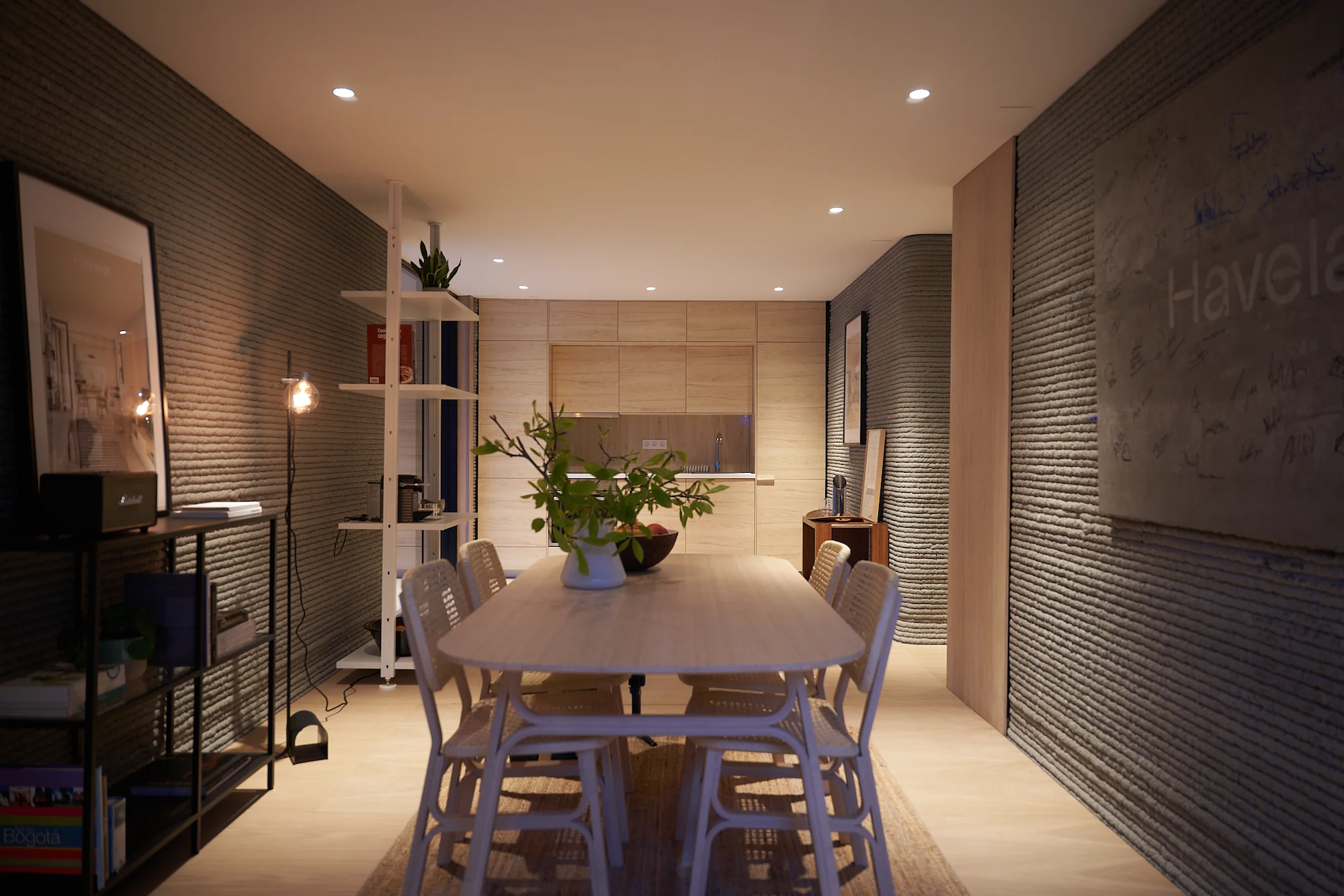 The 3D-printed house is arranged around a central kitchen and dining area