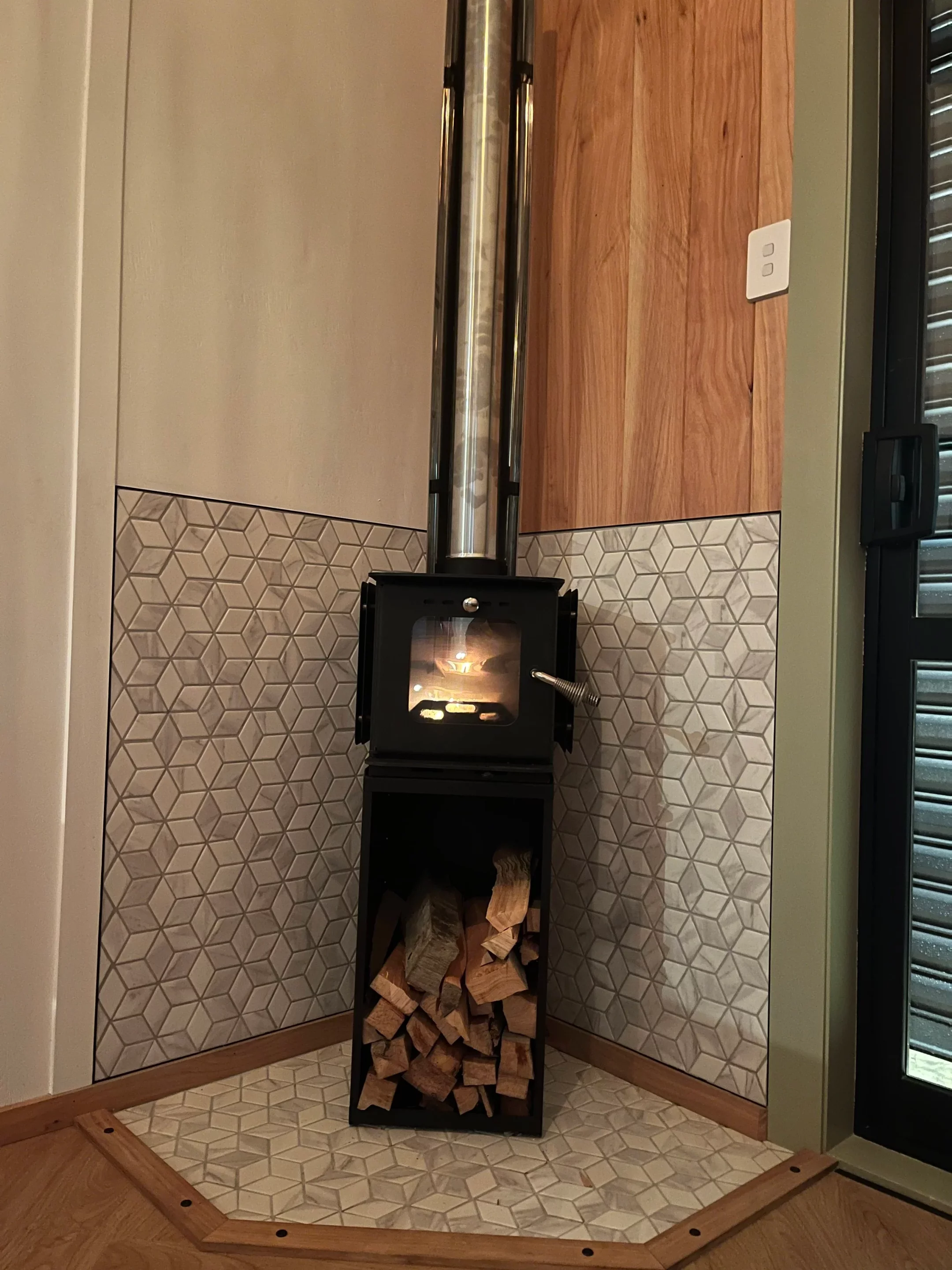 The Redwood's interior is heated with a small wood-burning stove installed in the living room