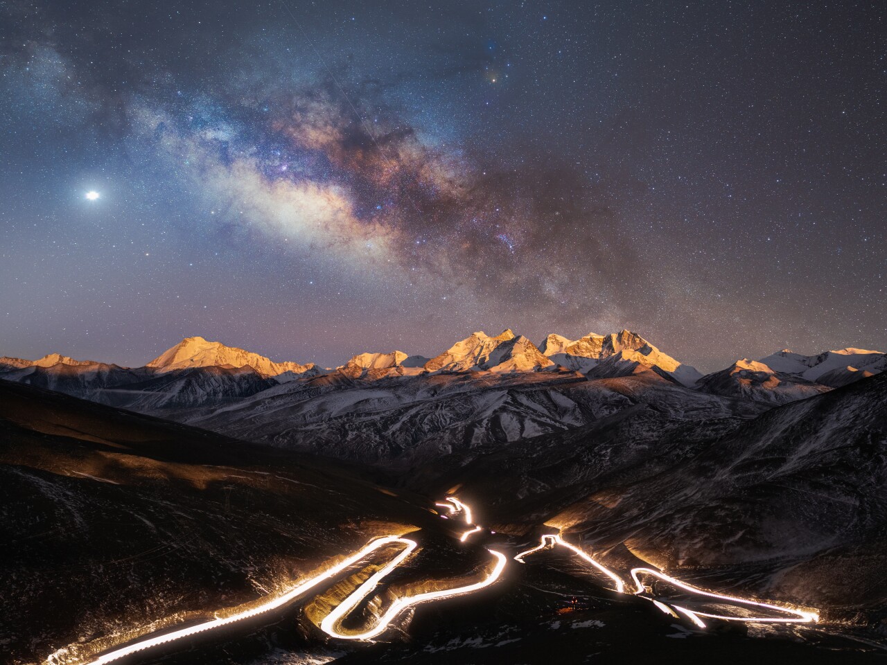People & Space. The Starry Sky Over the World’s Highest National Highway. The illuminated National Highway 219, the highest national highway in the world. Taken with SIGMA ILCE-1 camera, 20 mm f/2.8, ISO 800, 245-second total exposure. Shannan, Tibet.