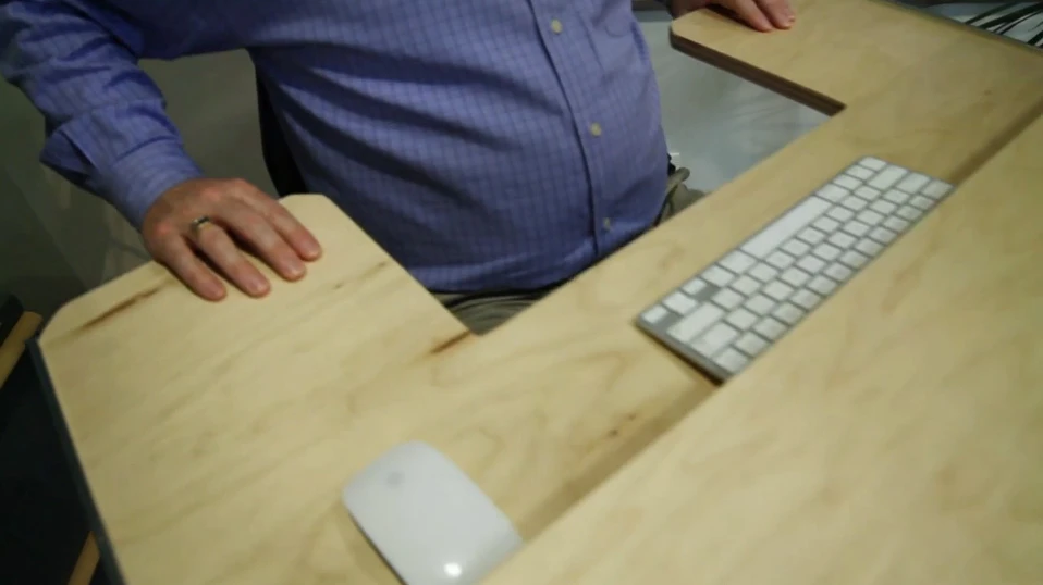 A sliding keyboard tray has wings to rest your elbows, allowing you to remain steady while pedaling and typing simultaneously