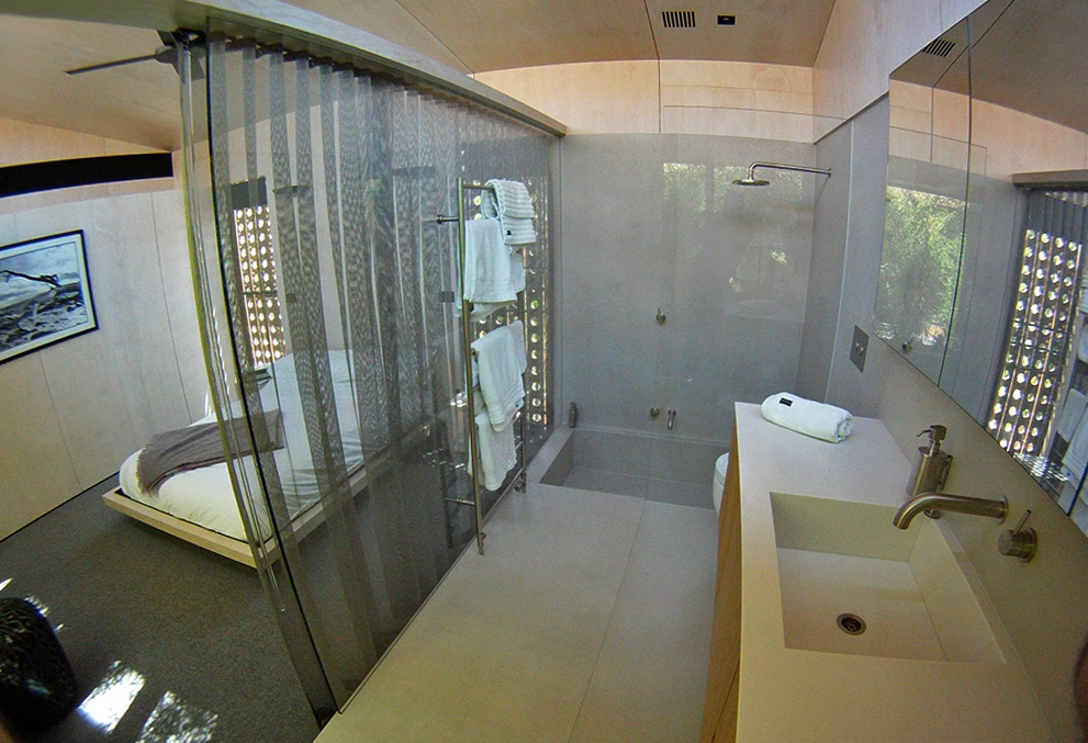 The en-suite, subtly separated from the bedroom by a metallic curtain (Photo: Edoardo Campanale for Gizmag)