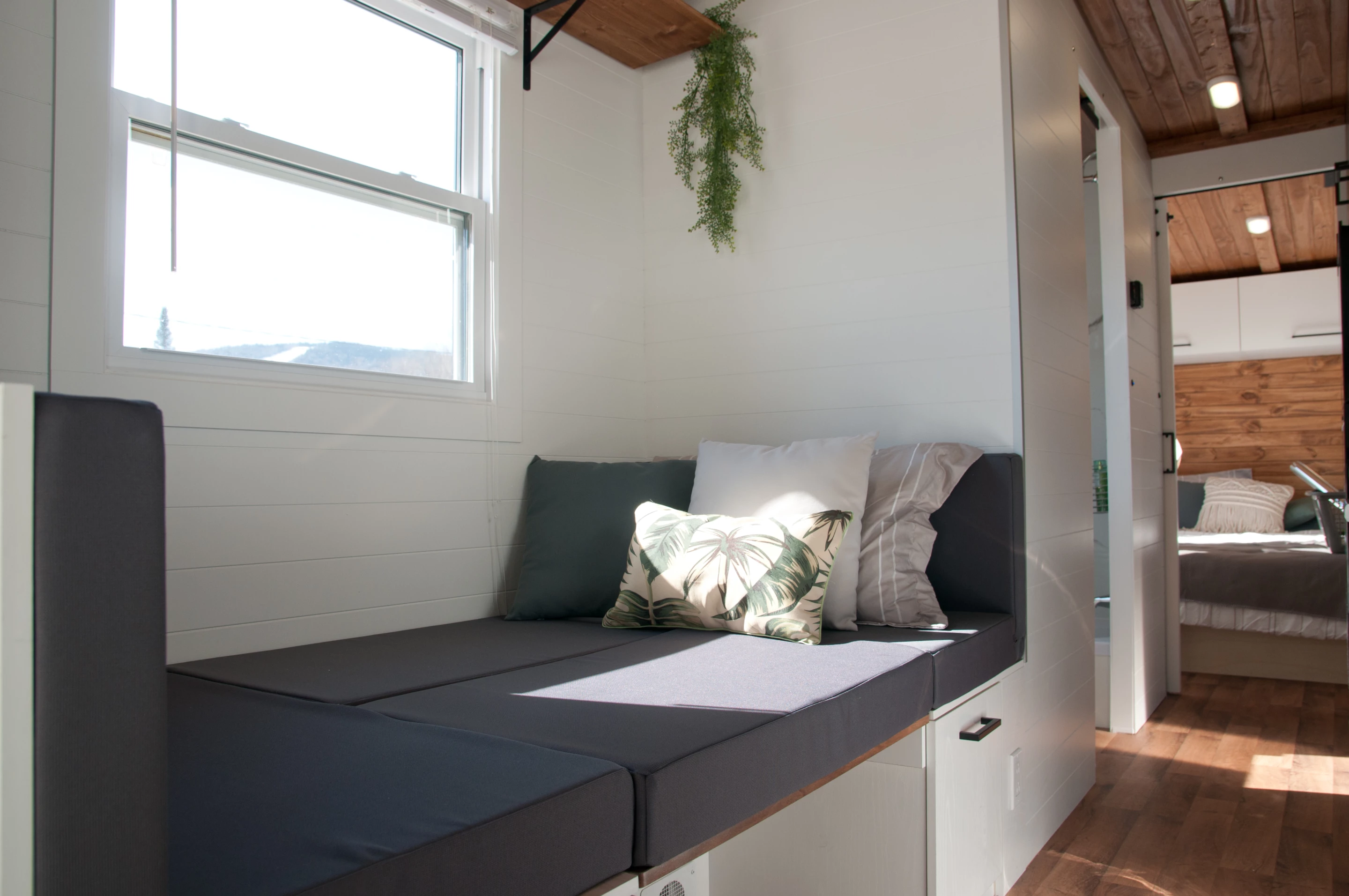 The Nomad's dining table can be combined with the bench seating to form a small bed