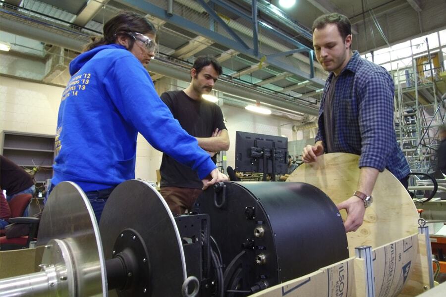 Mechanical Engineering master's student Siri Maley, Research Associate Mohammad Mousaei and Mechanical Engineering master's student Lawrence Papincak work with the RadPiper robot