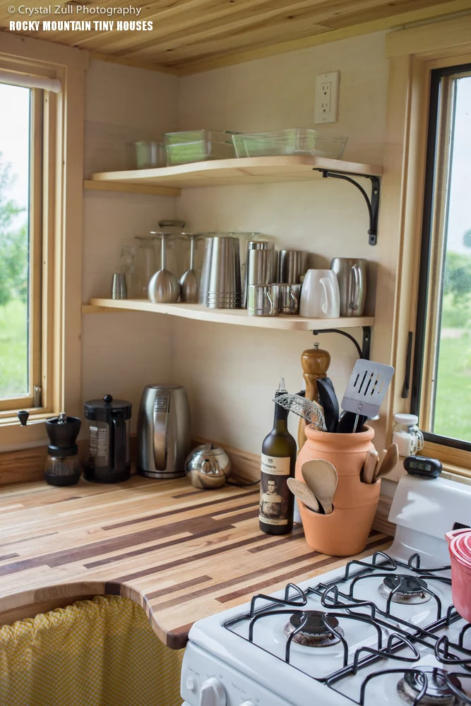 The kitchen boasts a full-size fridge freezer, a washing machine, a range cooker and a sink
