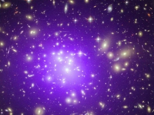A cluster of galaxies 2.3 billion light years away.Image Credit: X-ray: NASA/CXC/MIT/E.-H Peng. Optical: NASA/STScI