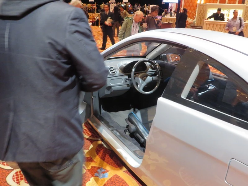 The Elio seats a single passenger directly behind the driver