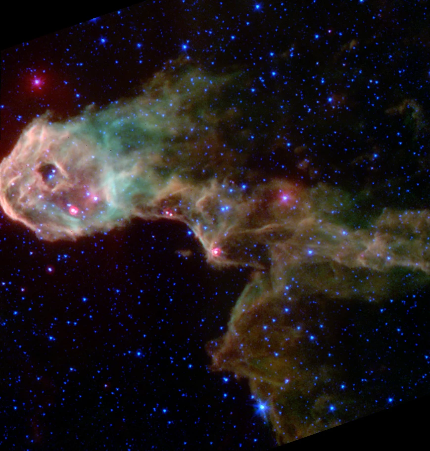 The Elephant’s Trunk Nebula is creating brand new stars. The bright red spots inside the dusty cloud are protostars that were obscured from view before Spitzer turned its infrared eyes on them.