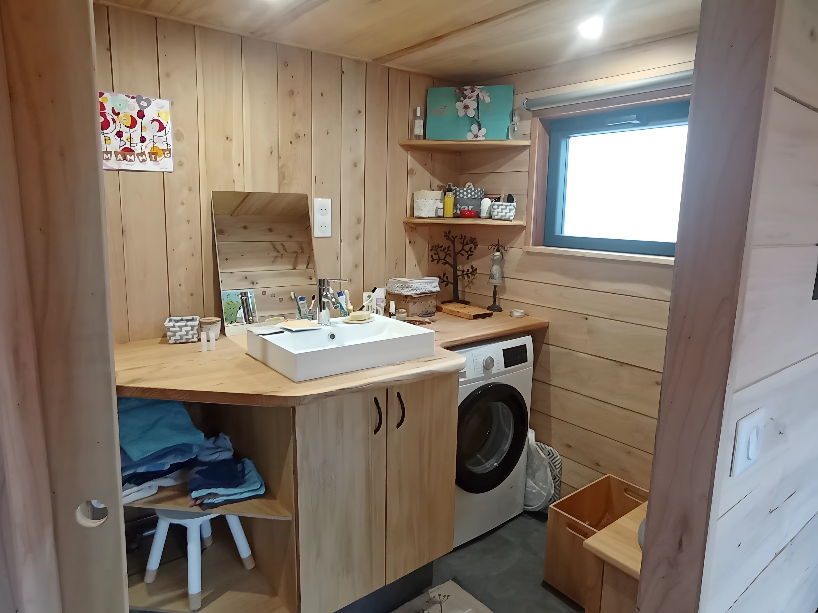 The Tiny XXL's bathroom includes a composting toilet, shower, and sink. Plus there's a combined washer/dryer installed