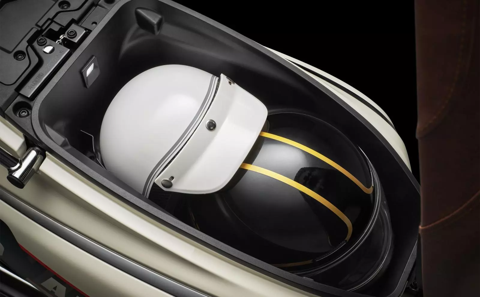 The 150 Aura gets a roomy seat bucket that can accommodate two quarter-face helmets