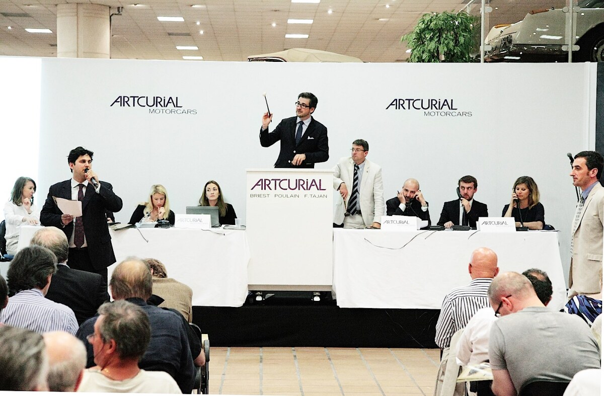 Matthieu Lamoure, the MD of Artcurial's automotive auction department is pictured during the 2012 auction of the private collection of automobiles belonging to the Prince of Monaco.