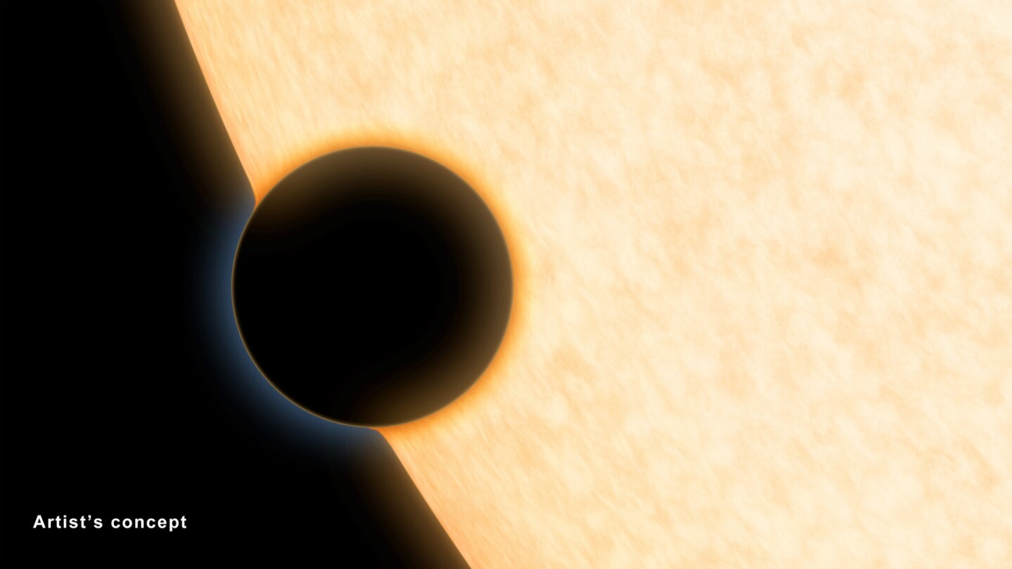 A Neptune-size planet with a clear atmosphere is shown crossing in front of its star in this artist's depiction