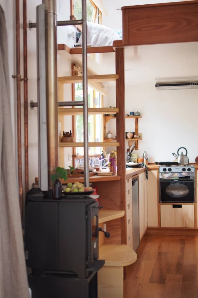 The kitchen features a two burner gas stove and gas oven/grill