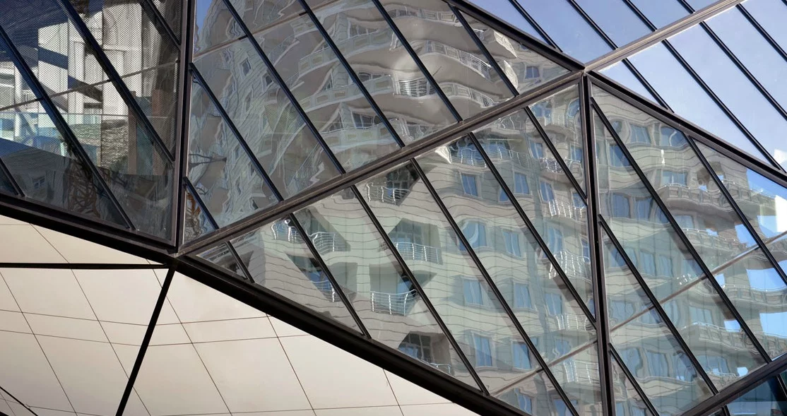 The building is further characterized by its angular glass exterior