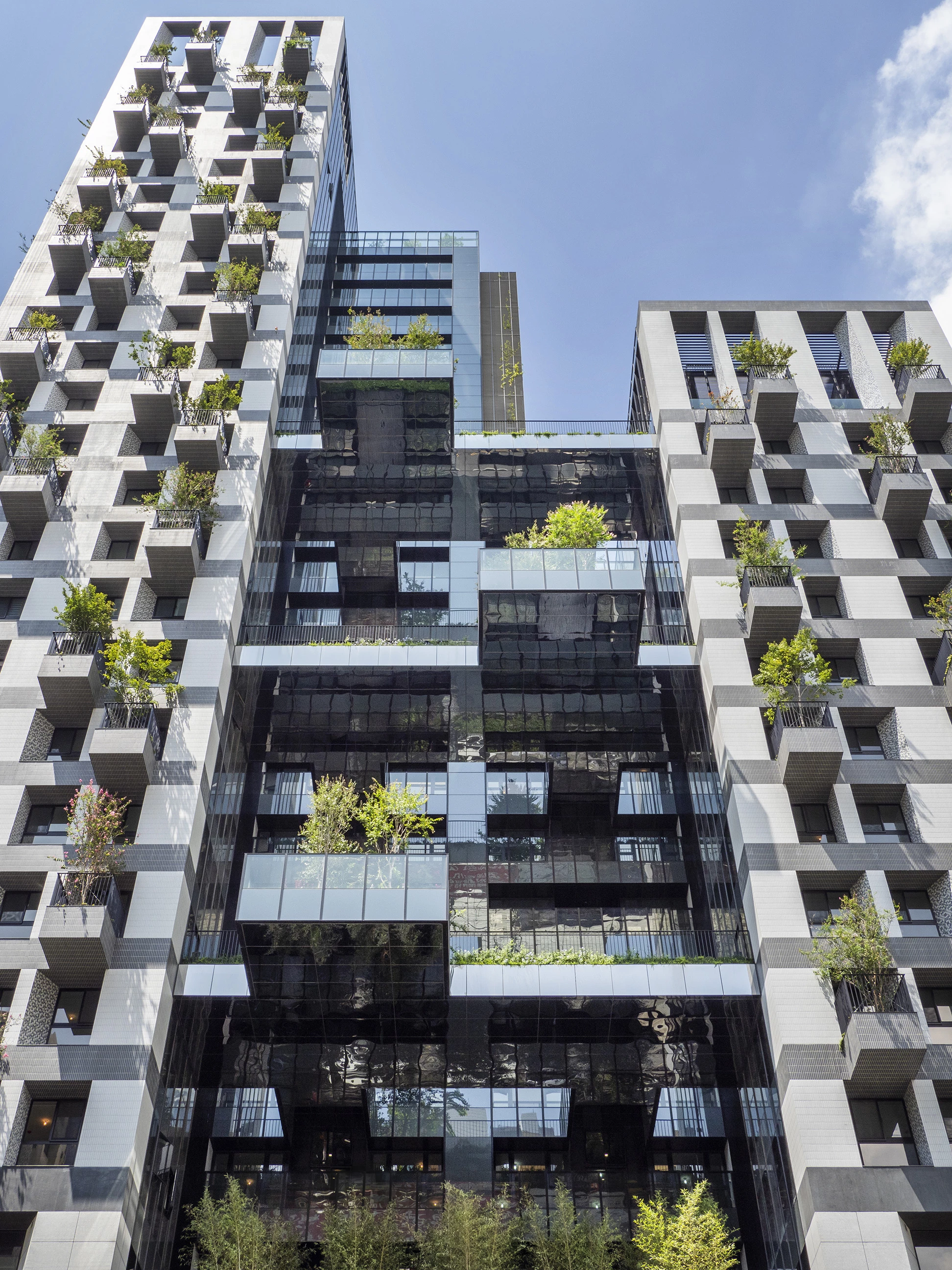"Large sky terraces at every five floors within the block extend the living space of residents from indoors to outdoors, creating a biophilic environment within a high-rise development," says WOHA