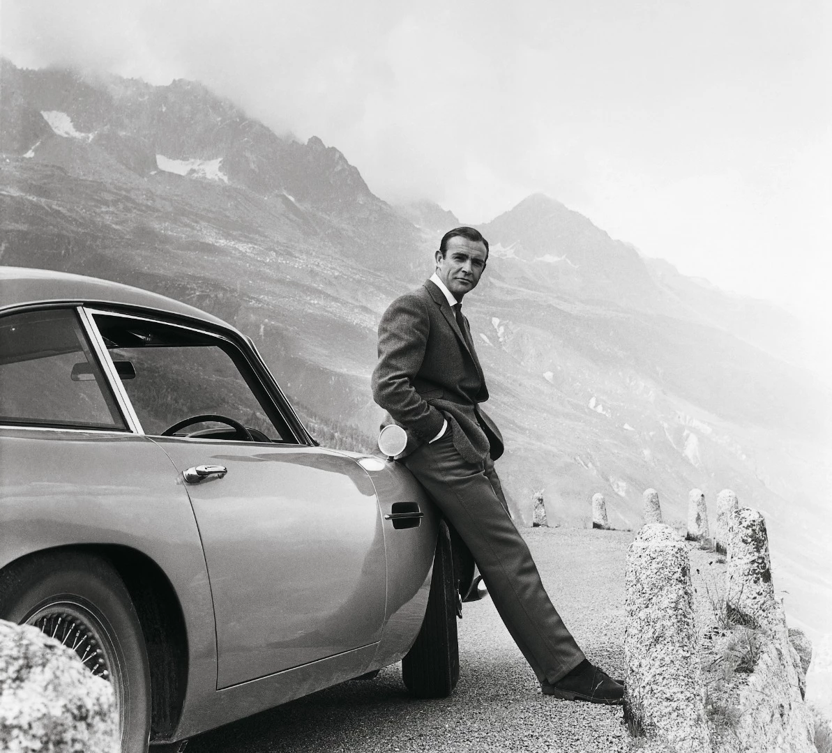 Sean Connery and the famous "Birch Silver" Aston Martin DB5 during the filming of "Goldfinger"