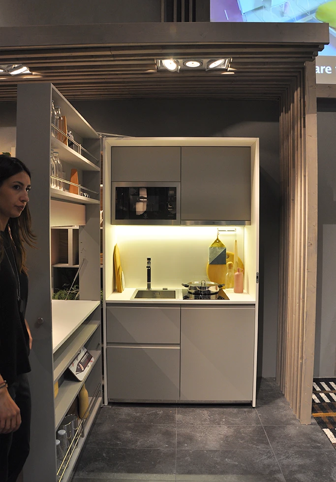 The kitchen's fixed wall feature includes a sink, induction hob with two cookers, 130 liter refrigerator, dish washer and microwave