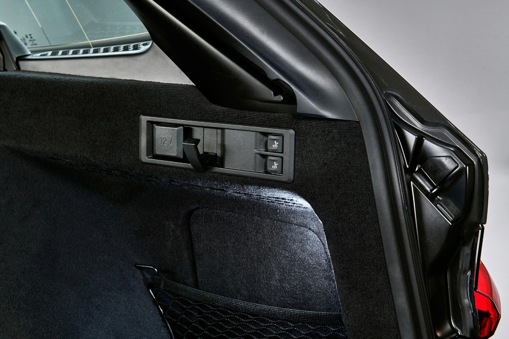 Grocery hooks and convenient seat fold-down buttons are found in the rear of the BMW 3 Series Touring model