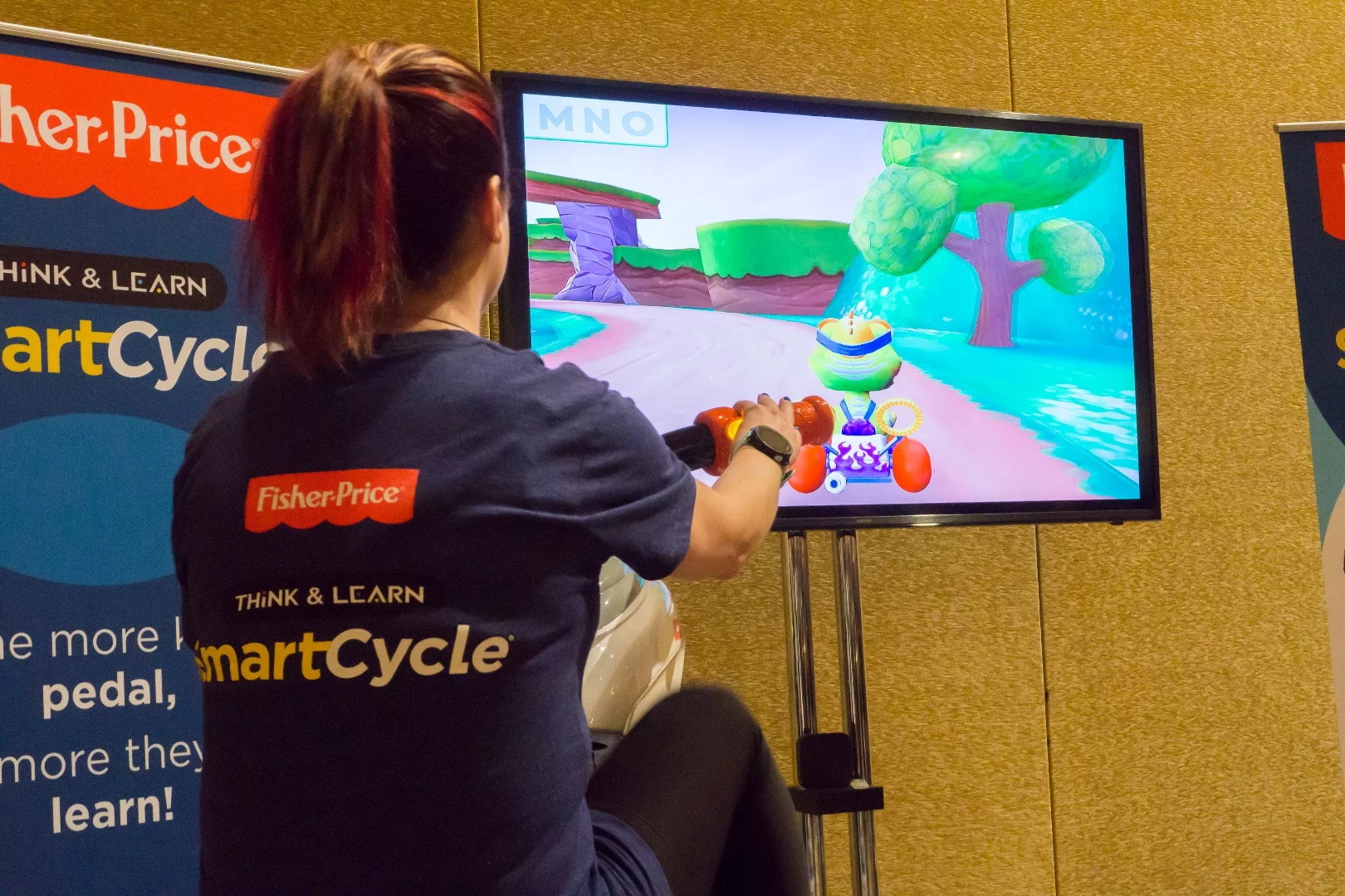 A big kid gets into some pedal-powered learning on a Smart Cycle at CES 2017