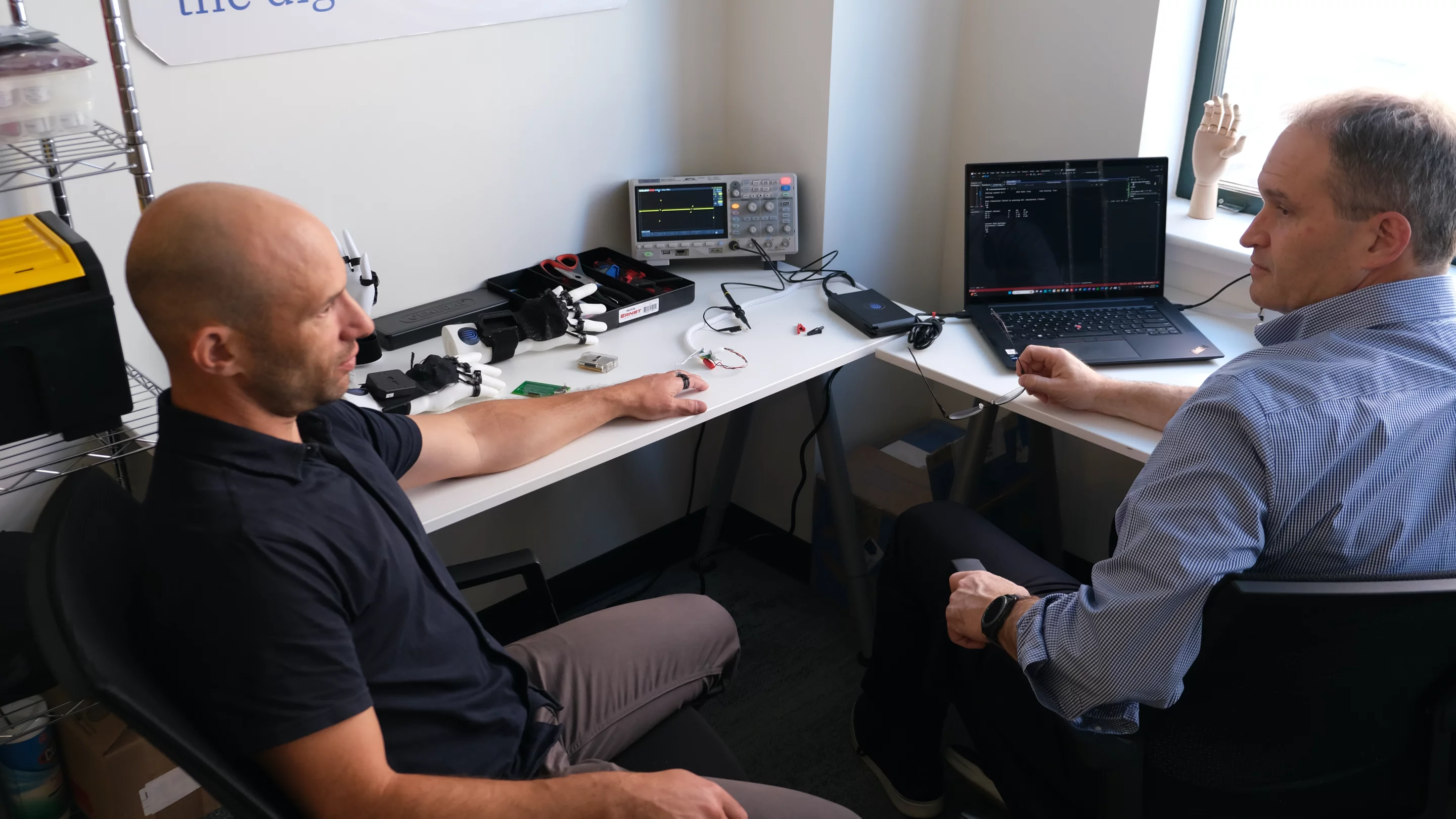 Afference founders Jacob Segil (left) and Dustin Tyler test their haptic feedback system