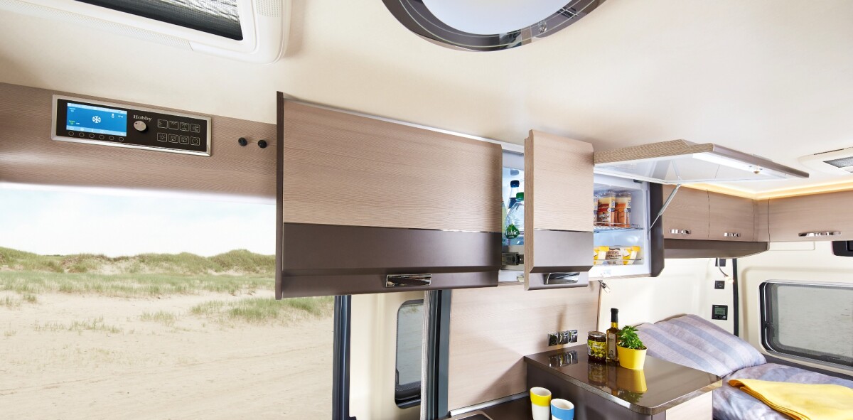 The SlimLine design includes two fridge compartments with swing-up doors and a slide-out drink drawer