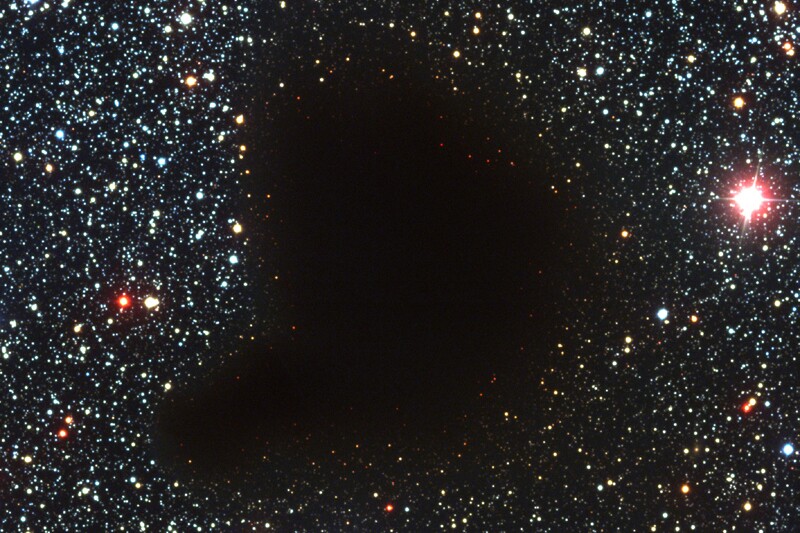 The Perseus cloud appears in the sky as a black spot, since it's made up of dense gas and dust that blocks light from stars inside and behind it