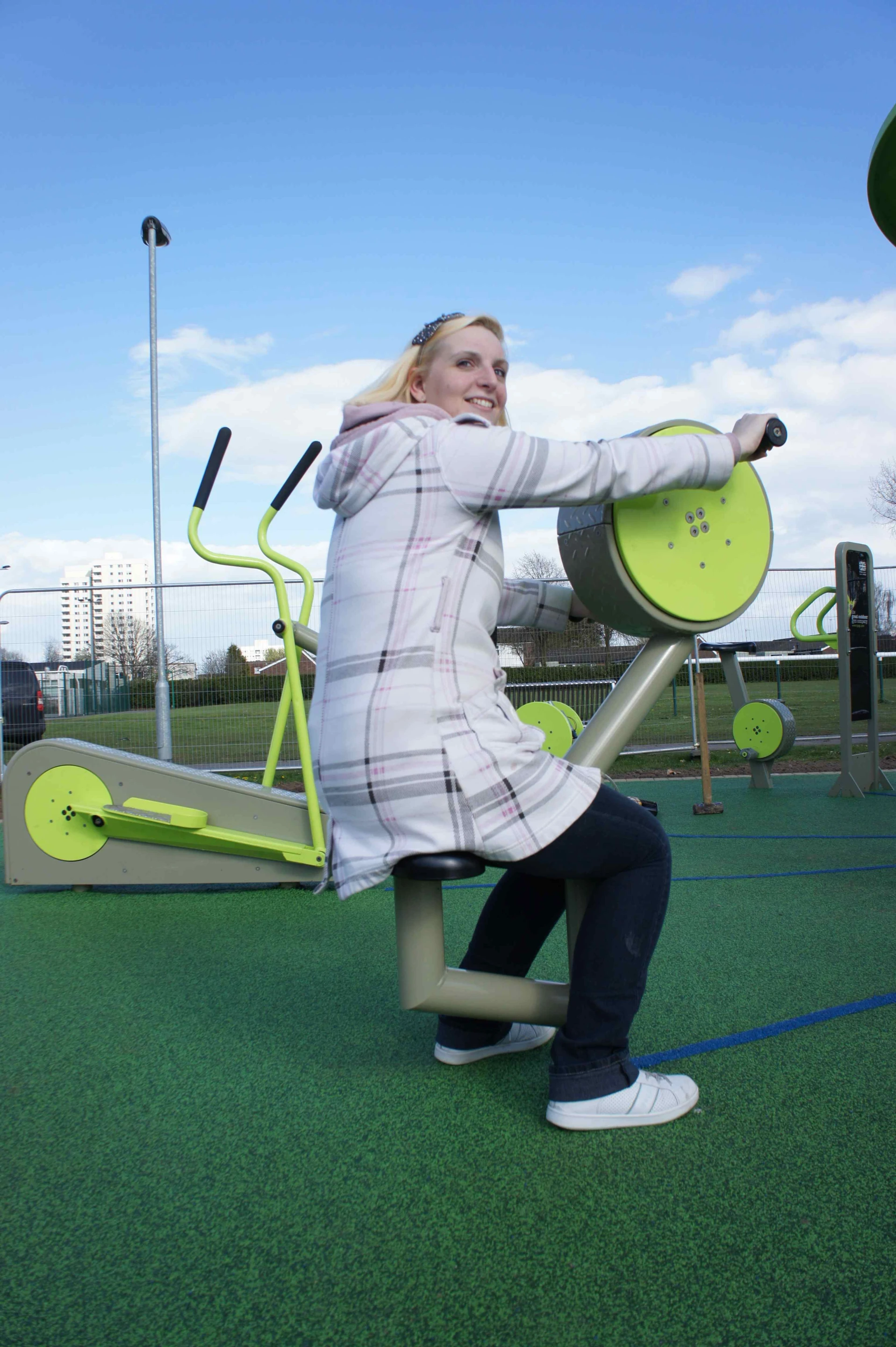 A user pumps the hand bike and helps generate power to light the TGO Green Heart outdoor gym at night