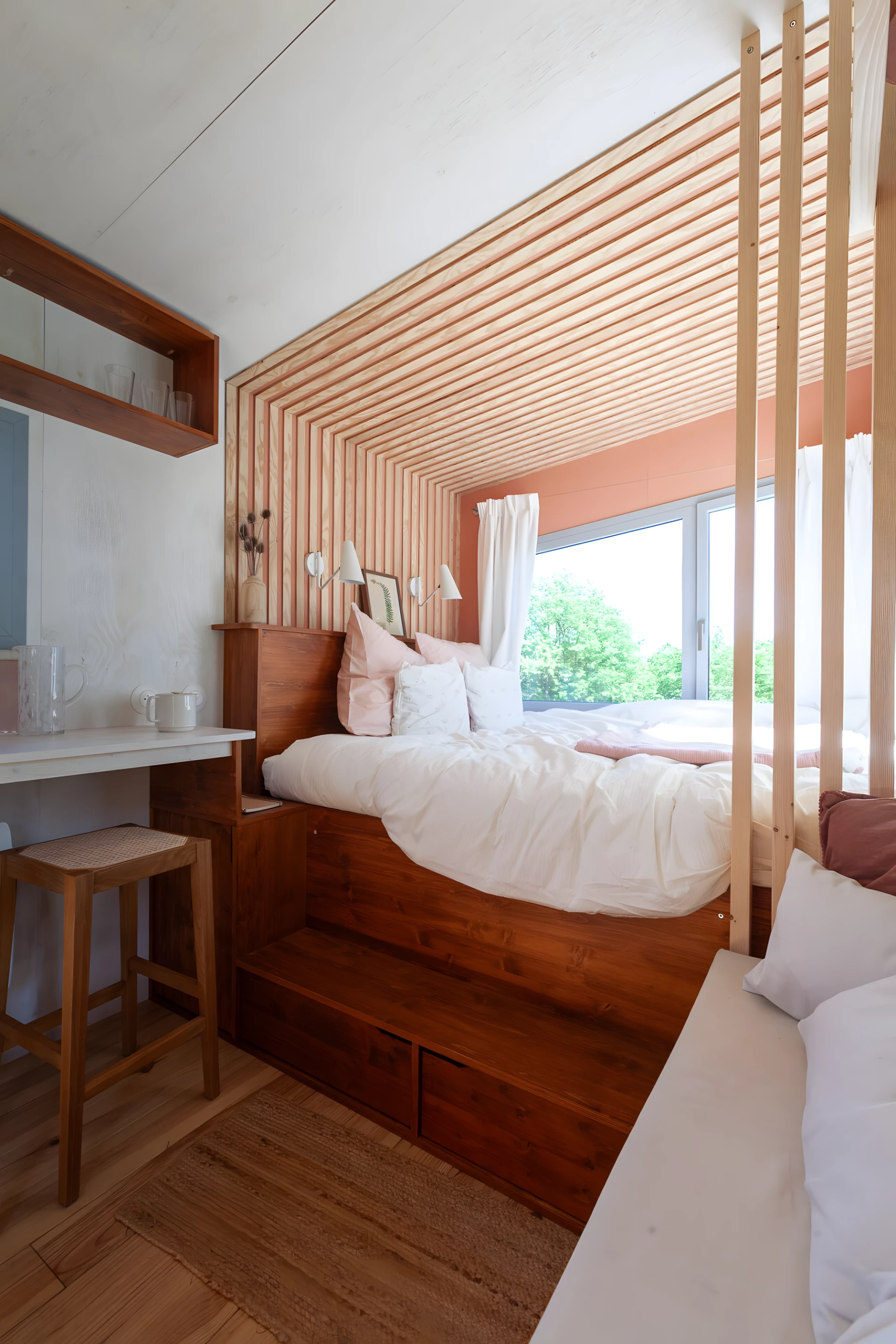 The Botanical Cabin's bed is raised on a platform, and features integrated storage space