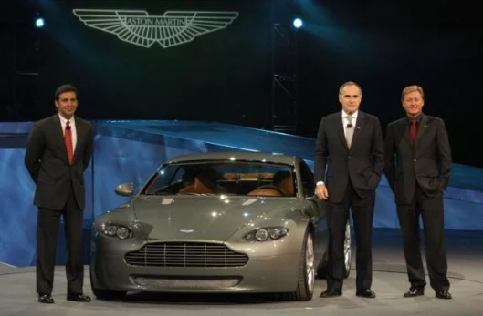 Fisker at right on stage in the unveiling of the Aston Martin V8 Vantage