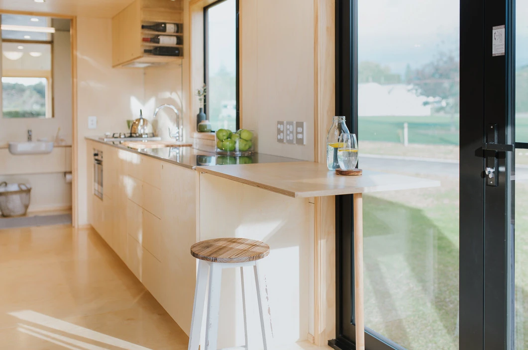 The First Light Tiny House has generous glazing and looks quite light-filled inside