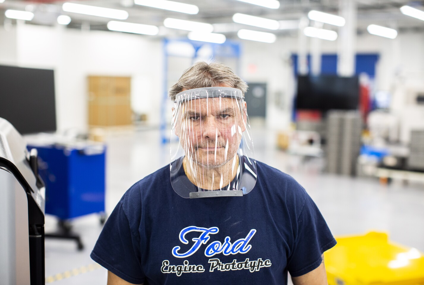 Dave Jacek, 3D printing technical, wears a prototype of a 3D-printed medical face shield printed at Ford’s Advanced Manufacturing Center