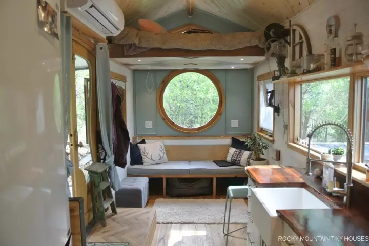 The San Juan Tiny House features a manually-elevated bed, seen here in the raised position