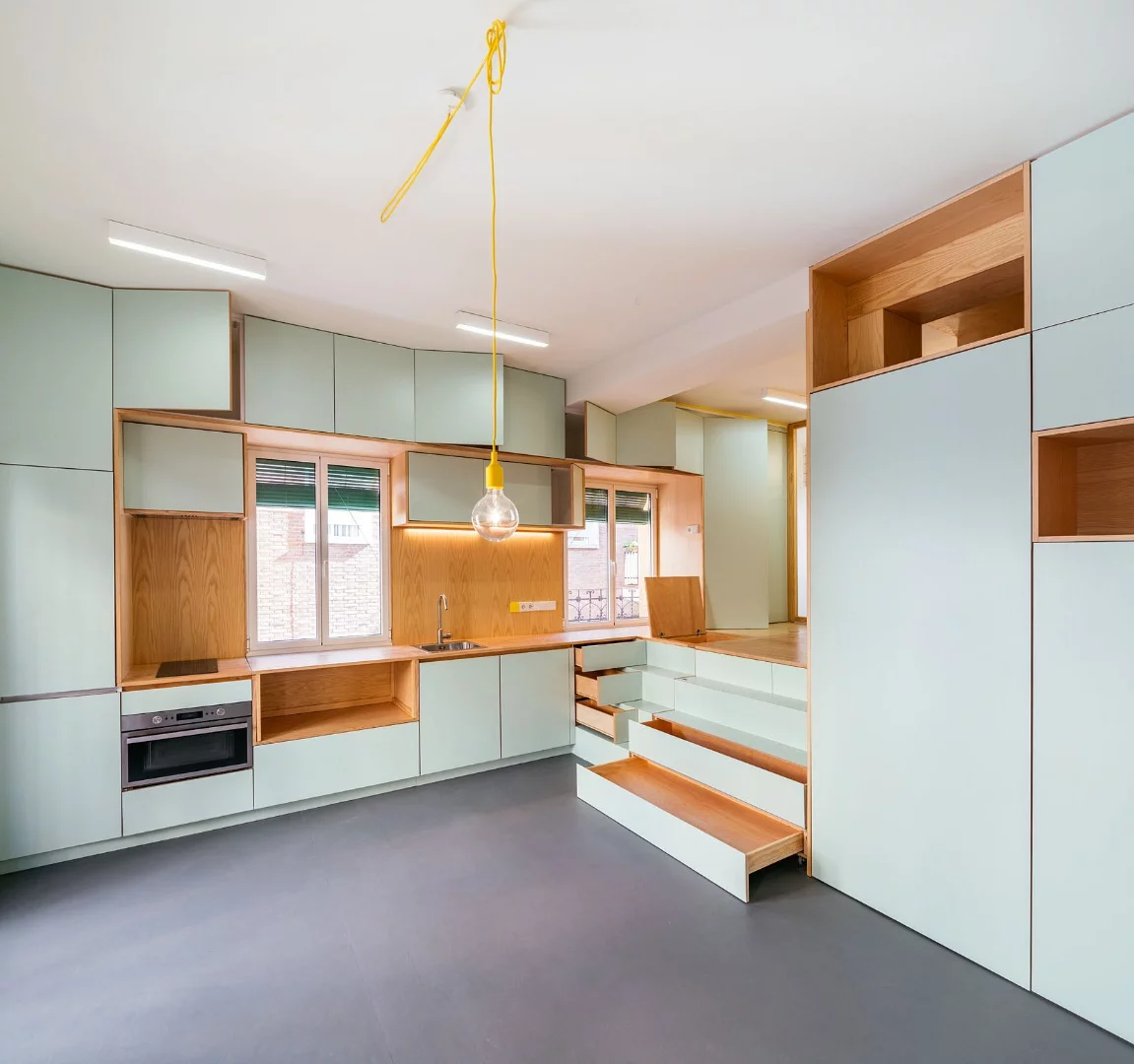 The core service station is designed over two distinct levels, creating an elevated sleeping zone and a hidden bathroom area