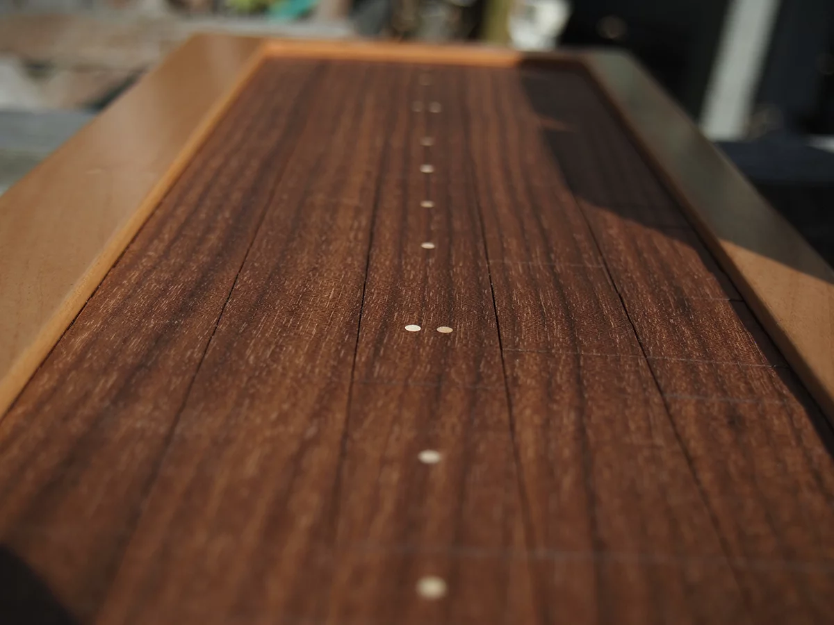 The playing surface of the Soundplane Model A features a custom-made articulated sheet of walnut veneer bonded to a fiber backing that can be configured as a 150 note keyboard - with position and pressure-sensing on each key - or as one continuous surface