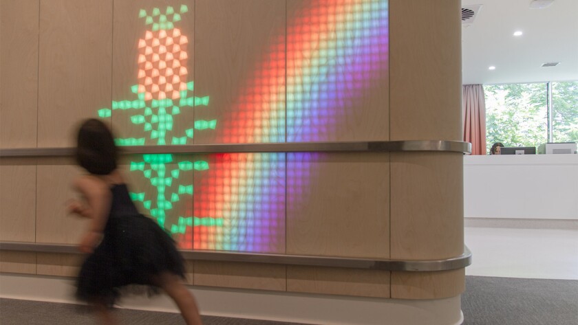 As people walk past the Lumes wall, animals peek their heads out of grass that grows with movement, raindrops fall, rockets launch, and runners follow the human movements